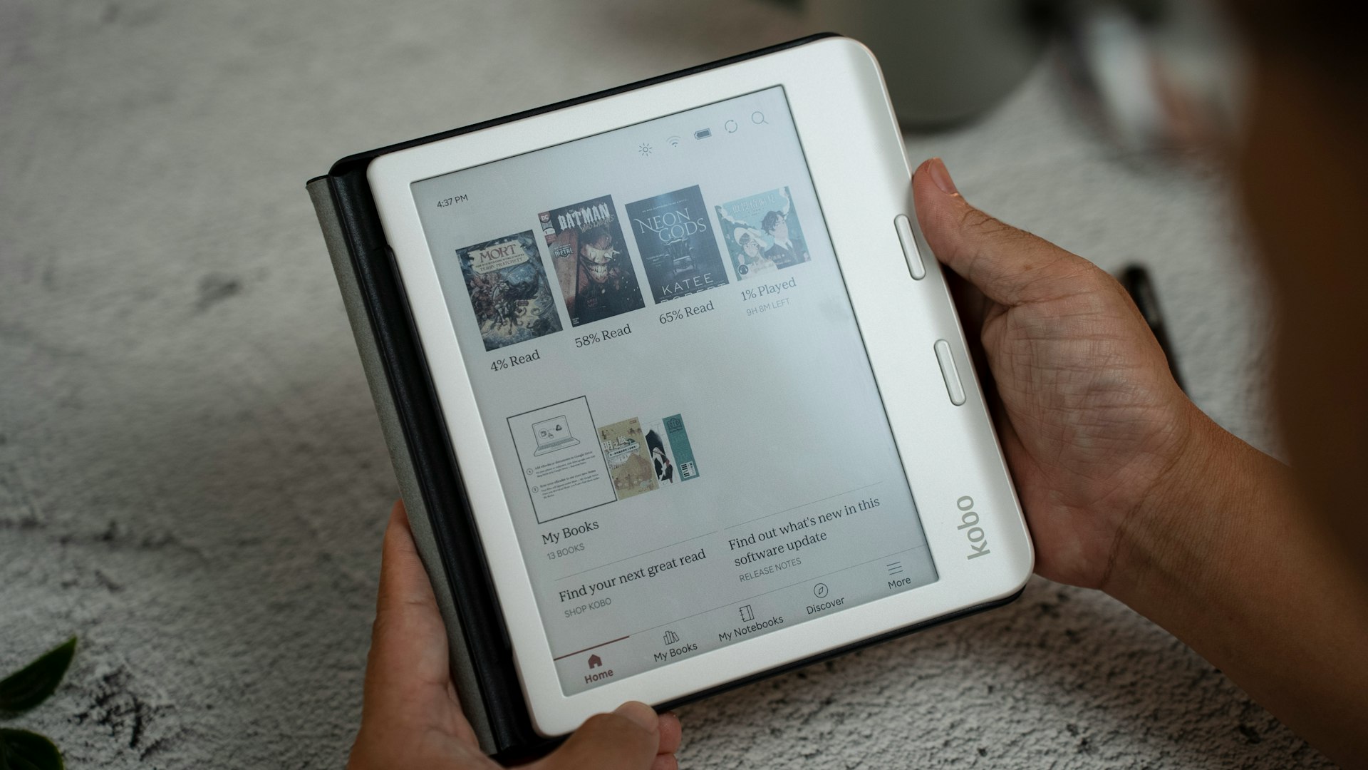 A person holding a tablet with a page on it